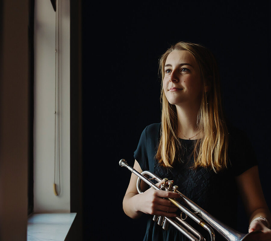 a student in the popular music degree holds a trumpet