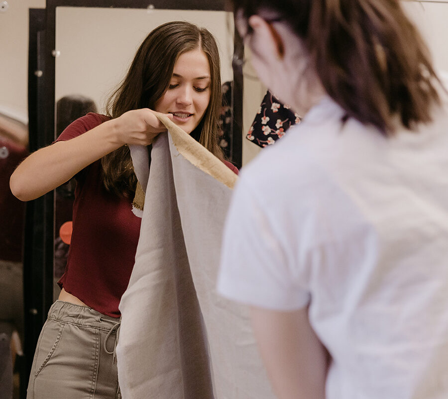 students from the degree in theatre arts making a costume with fabric
