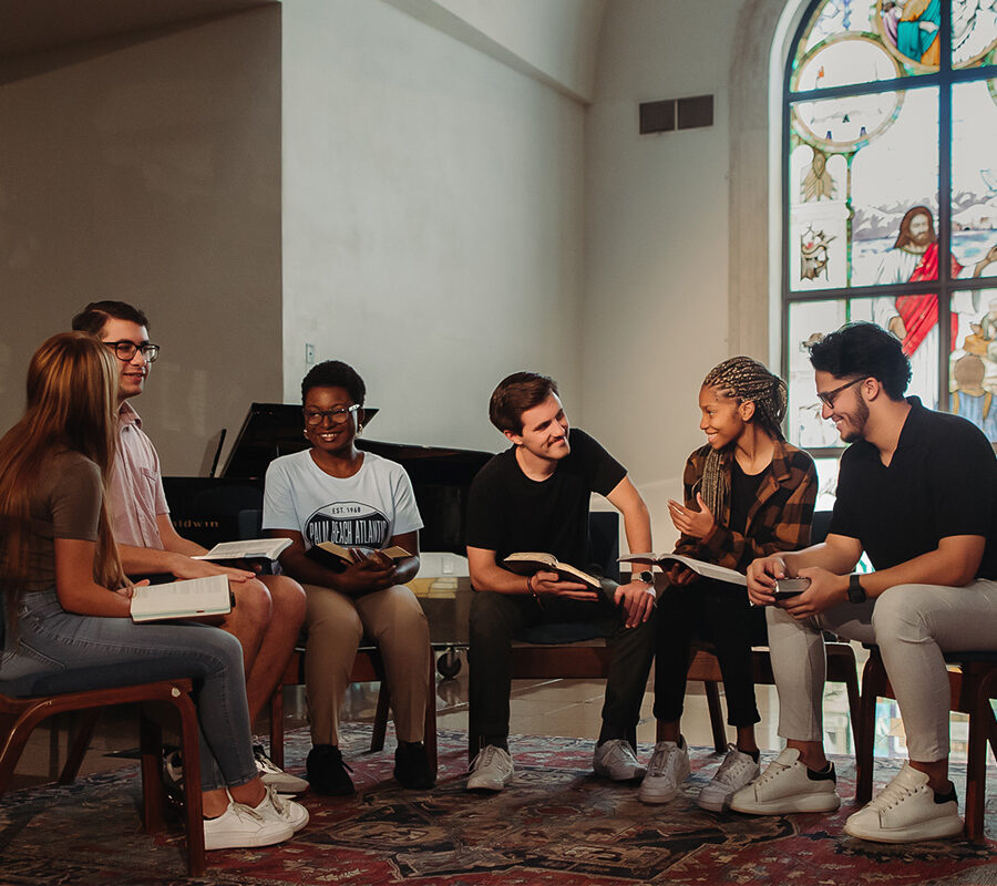 Christian Studies and Community Development students read together in a chapel.