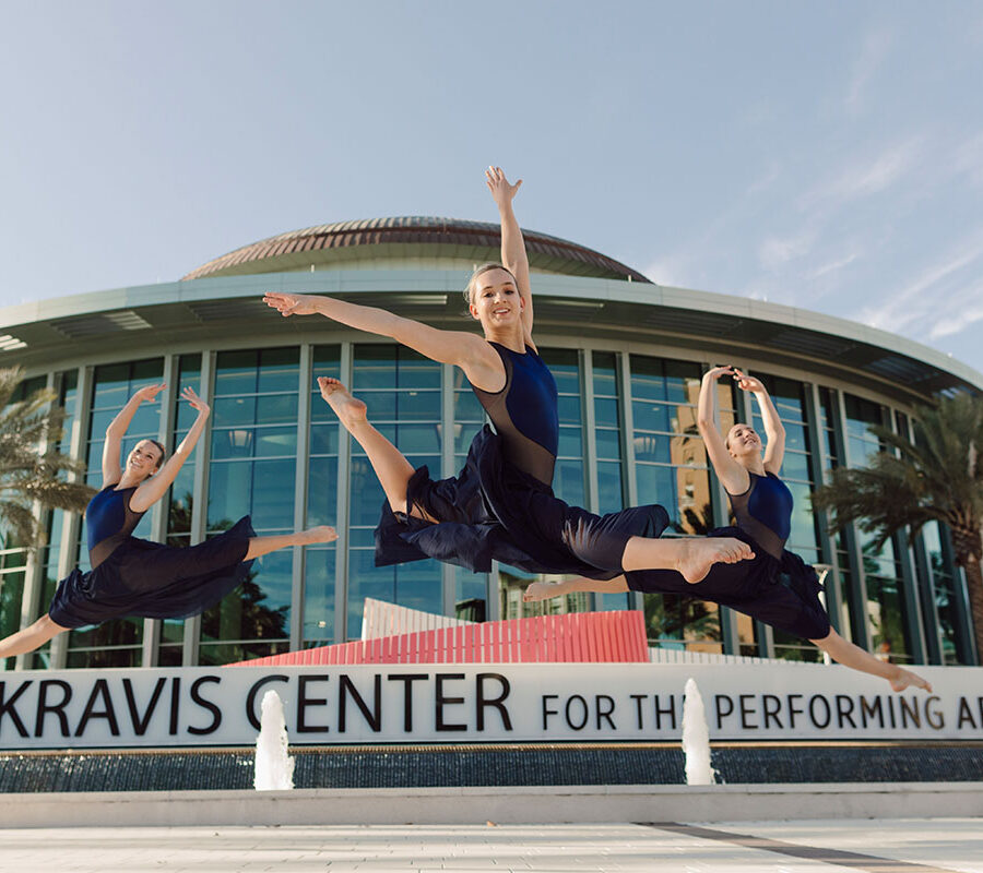 Three dance students perform outside the Kravis Center.