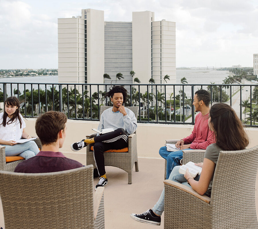 PBA students sit in a circle and talk.