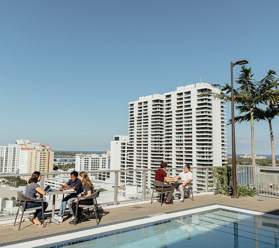 community development students sitting at tables on the rooftop of a building