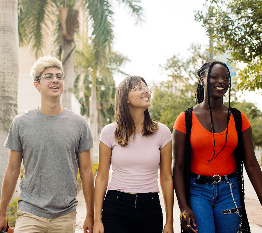 three PBA students program walk together on campus