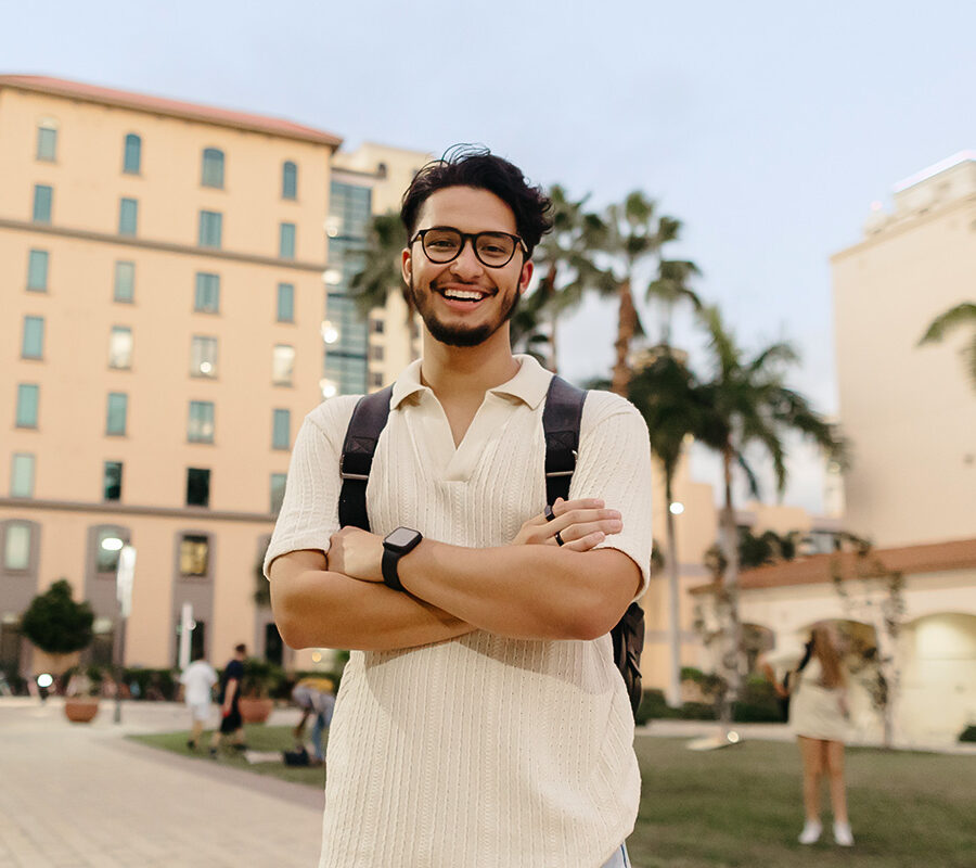 biblical studies minor student stands with arms folded on the PBA campus.